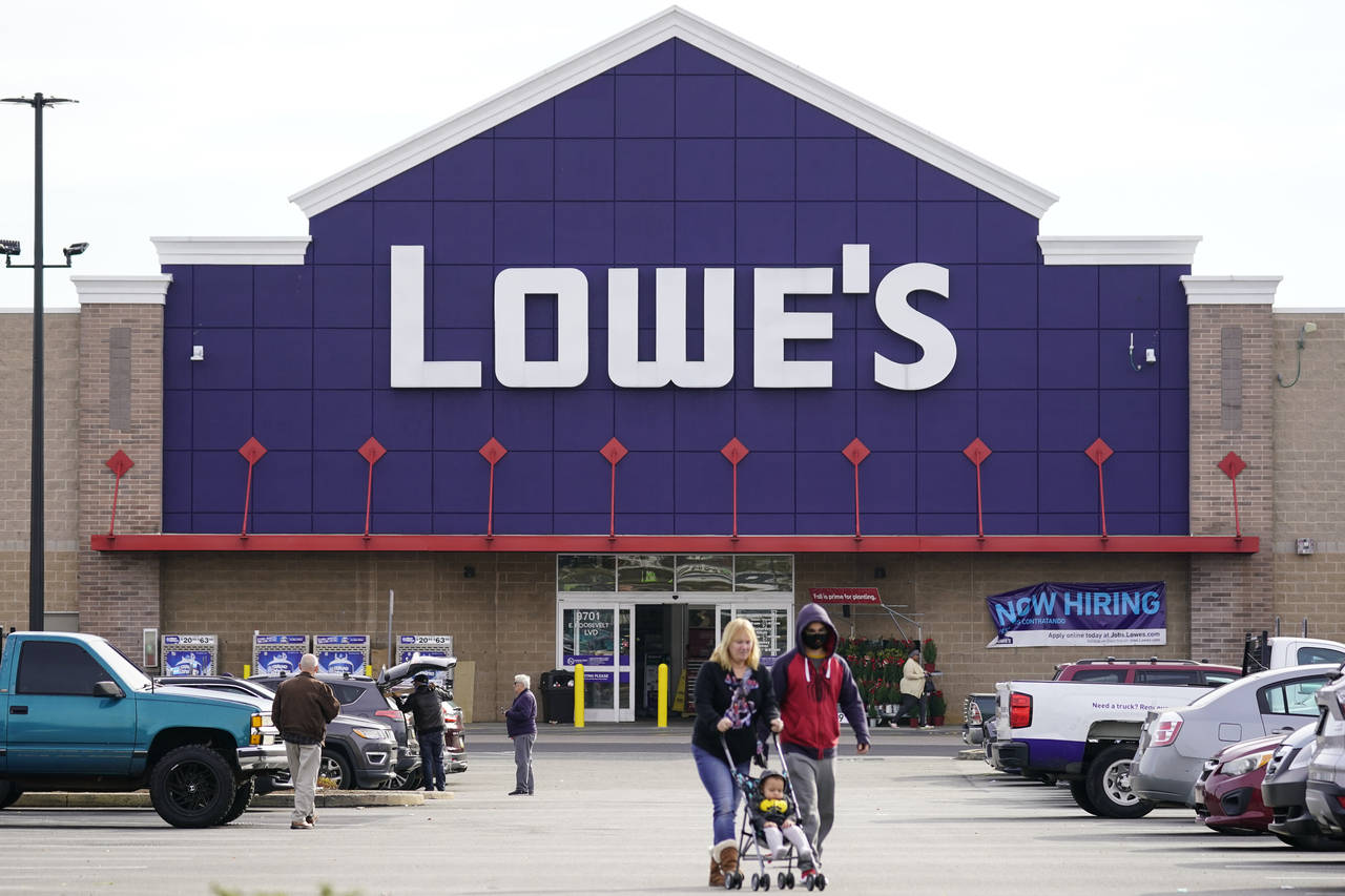 Shoppers walk in the lot of a Lowe's home improvement store in Philadelphia, Wednesday, Nov. 17, 20...