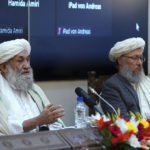 
              Taliban Prime Minister Mohammad Hasan Akhund, left, speaks during an economic conference at the former Presidential Palace in Kabul, Afghanistan, Wednesday, Jan. 19, 2022. Afghanistan's Taliban rulers are holding their first economic conference, five months since taking over the country that is now teetering on the verge of a humanitarian catastrophe and economic collapse. The U.N. head of mission for Afghanistan said at the gathering on Wednesday that  surprising $1 billion in exports. (Taliban Prime Minister Media Office via AP)
            