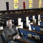 
              FILE - The Rev. Alvin J. Gwynn Sr., of Friendship Baptist Church in Baltimore, sits in his church's sanctuary, Thursday, March 19, 2020. Amid the coronavirus pandemic, the predominantly Black church received a PPP loan of more than $55,000, but that barely made a dent in expenses. Gwynn has given up his pastor’s salary and for now is living off Social Security checks and his other job in construction. (AP Photo/Steve Ruark, File)
            