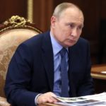 
              Russian President Vladimir Putin listens during a meeting at the Kremlin in Moscow, Russia, Friday, Jan. 14, 2022. (Mikhail Metzel, Sputnik, Kremlin Pool Photo via AP)
            