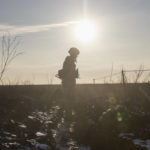 
              An Ukrainian soldier walks on the line of separation from pro-Russian rebels, in Mariupol, Donetsk region, Ukraine, Thursday, Jan. 20, 2022. President Joe Biden has warned Russia's Vladimir Putin that the U.S. could impose new sanctions against Russia if it takes further military action against Ukraine. U.S. Secretary of State Antony Blinken is warning of a unified, "swift, severe" response from the United States and its allies if Russia sends any military forces into Ukraine. (AP Photo/Andriy Dubchak)
            