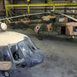 
              FILE - Damaged Afghan military helicopters are parked inside the Hamid Karzai International Airport after the Taliban's takeover, in Kabul, Afghanistan, Sept. 5, 2021. A year-old report by Washington’s Afghanistan watchdog warned in early 2021, months before President Joe Biden announced the end to America’s longest war, the Afghan air force would collapse without critical U.S. aid, training and American maintenance. The report by the Special Inspector General for Afghanistan Reconstruction John Sopko was classified back when it was written and only declassified on Tuesday, Jan. 18, 2021. (AP Photo/Mohammad Asif Khan, File)
            