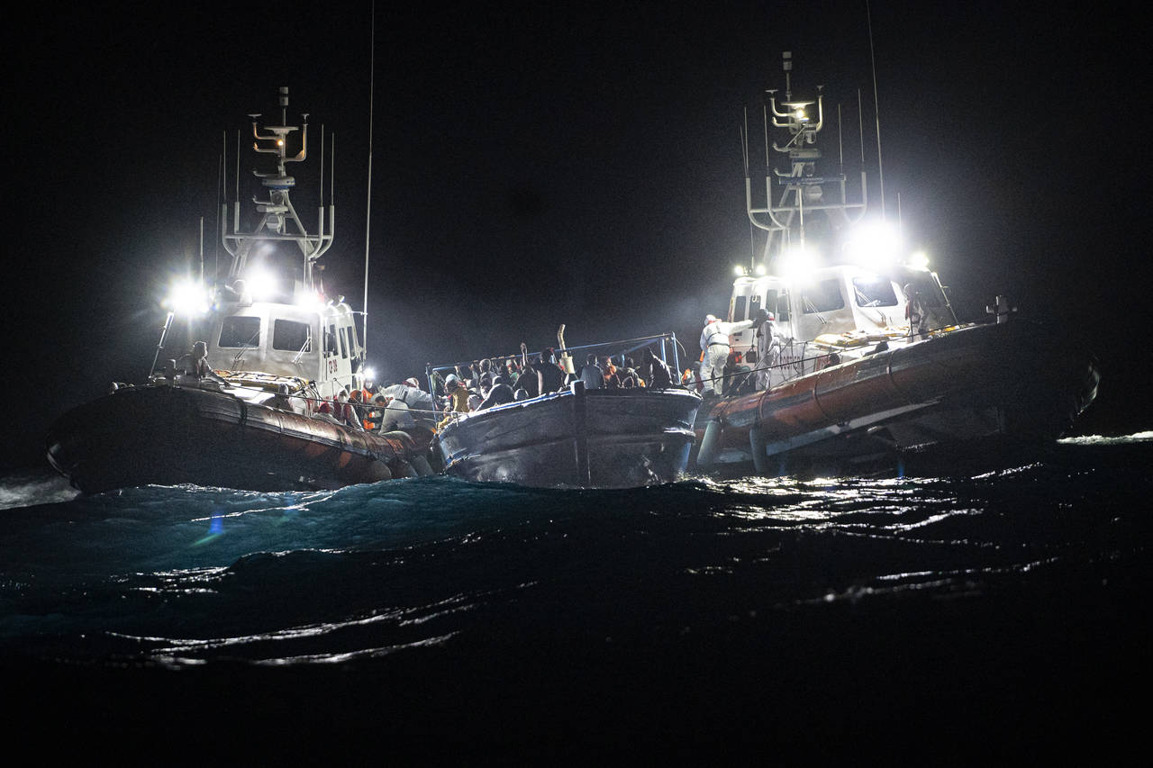 Migrants are rescued off the coast of Lampedusa on Tuesday Jan. 25, 2022. Seven migrants have died ...