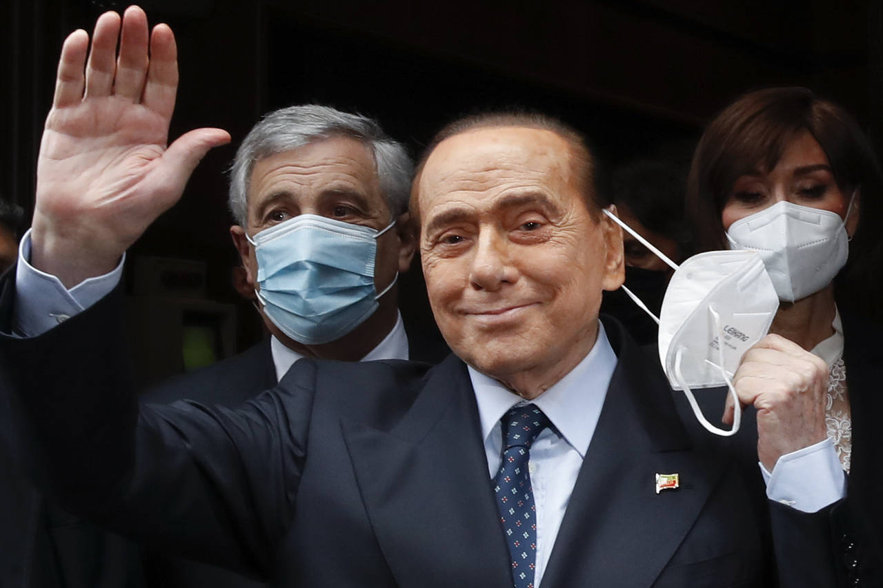 FILE - Former Italian Premier Silvio Berlusconi waves to reporters as he arrives at the Chamber of ...