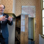
              Ronald Leopold, executive director Anne Frank House, gestures as he talks next to the passage to the secret annex during an interview in Amsterdam, Netherlands, Monday, Jan. 17, 2022. A cold case team that combed through evidence for five years may have solved one of World War II's enduring mysteries: Who betrayed Jewish teenage diarist Anne Frank and her family? Their answer, outlined in a new book, is that it most likely was a Jewish lawyer called Arnold van den Bergh. (AP Photo/Peter Dejong)
            