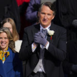 
              Gov. elect Glenn Youngkin with wife Suzanne Youngkin wave to the crowd before his inauguration ceremony, Saturday, Jan. 15, 2022, in Richmond, Va. (AP Photo/Julio Cortez)
            