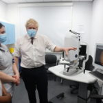 
              Britain's Prime Minister Boris Johnson gestures, during a visit to Finchley Memorial Hospital, in North London, Tuesday, Jan. 18, 2022. (Ian Vogler, Pool Photo via AP)
            