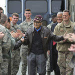 
              FILE- Retired U.S. Air Force Col. Charles McGee, center, a decorated veteran of three wars, receives a congratulatory send off after visiting with 436 Aerial Port Squadron personnel at Dover Air Force Base to help celebrate his 100th birthday in Dover, Delaware, Friday, Dec. 6, 2019. McGee, one of the last surviving Tuskegee Airmen who flew 409 fighter combat missions over three wars, died Sunday, Jan. 16, 2022. He was 102.  (AP Photo/David Tulis, File)
            