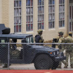 
              Law enforcement teams stage near Congregation Beth Israel while conducting SWAT operations in the 6100 block of Pleasant Run Road on Saturday, Jan. 15, 2022, in Colleyville, Texas. Authorities said a man took hostages Saturday during services at the Texas synagogue. (Smiley N. Pool/The Dallas Morning News via AP)
            