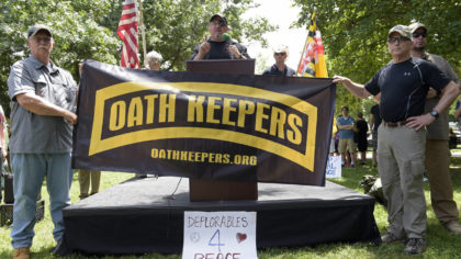 FILE - Stewart Rhodes, founder of the citizen militia group known as the Oath Keepers, center, spea...