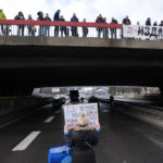 
              A Environmental demonstrator holds a  banner reading "Because: we don't have other country, other water and air!" as a highway is blocked, during a protest in Belgrade, Serbia, Saturday, Jan. 15, 2022. Hundreds of environmental protesters demanding cancelation of any plans for lithium mining in Serbia took to the streets again, blocking roads and, for the first time, a border crossing. Traffic on the main highway north-south highway was halted on Saturday for more than one hour, along with several other roads throughout the country, including one on the border with Bosnia. (AP Photo/Darko Vojinovic)
            