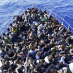 
              FILE - In this photo released by the Libyan coast guard, African migrants who were on boats in distress in the Mediterranean on their way to Europe, and rescued by the Libyan coast guard arrive to shore, east of the capital, Tripoli, Libya June 24, 2018. A confidential European Union military report calls for the continued support and training of Libya’s coastguard and navy despite concerns about their treatment of migrants, a mounting death toll at sea, and the continued lack of any central authority in the North African nation. The report circulated to EU officials on Jan. 4 and obtained by The Associated Press offers a rare insight into Europe’s determination to cooperate with Libya and its role in the interception and return of thousands of men, women and children to a country where they face insufferable abuse. (Libyan Coast Guard via AP)
            