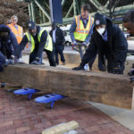 
              Virginia Gov.-elect Glenn Youngkin, top center, works to place a bench at the site of the Reconciliation statue Friday Jan. 14, 2022, in Richmond, Va. Youngkin will be sworn in as Virginia's 74th Governor Saturday. (AP Photo/Steve Helber)
            