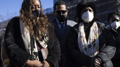 Members of National Action Network pray during a news conference near the scene of shooting in Harl...