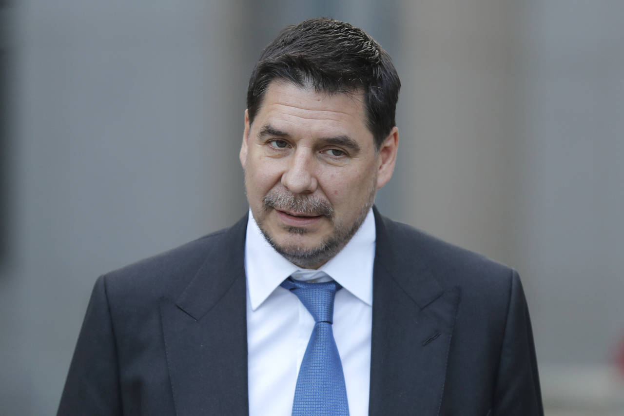FILE - In this Jan. 15, 2020, file photo, Sprint CEO Marcelo Claure speaks to reporters as he leave...