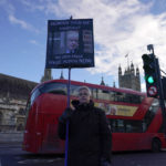 
              A man holds a placard outside the Houses of Parliament in Westminster, in London, Wednesday, Jan. 19, 2022.(AP Photo/Alberto Pezzali)
            