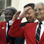 
              FILE- From left, Tuskegee Airmen, Cicero Satterfield, left, Lucius Theus, center, and Charles McGee, right, salute while posing for a group photo on the steps of the Capitol during a ceremony kicking off a nationwide fundraising drive for a memorial to the Tuskegee Airmen, Monday Dec. 18, 2006, in Montgomery, Ala.  McGee, one of the last surviving Tuskegee Airmen who flew 409 fighter combat missions over three wars, died Sunday, Jan. 16, 2022. He was 102. (AP Photo/Rob Carr, File)
            