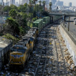 
              A train passes by as shredded boxes and packages at a section of the Union Pacific train tracks in downtown Los Angeles Friday, Jan. 14, 2022. Thieves have been raiding cargo containers aboard trains nearing downtown Los Angeles for months, leaving the tracks blanketed with discarded packages. The sea of debris left behind included items that the thieves apparently didn't think were valuable enough to take, CBSLA reported Thursday. (AP Photo/Ringo H.W. Chiu)
            