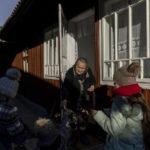 
              Children are handed money as a gift while celebrating the Malanka festival in the village of Krasnoilsk, Ukraine, Thursday, Jan. 13, 2022. (AP Photo/Ethan Swope)
            