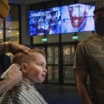 
              Three-year-old Ole van Santen gets a haircut at the Van Gogh museum in Amsterdam, Wednesday, Jan. 19, 2022, as Dutch museums, theaters and concert halls played host Wednesday to businesses that are allowed to open to customers as a protest against their own continuing lockdown closures. (AP Photo/Peter Dejong)
            
