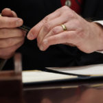 
              Virginia Gov. Glenn Youngkin prepares to sign executive orders in the governors conference room at the Capitol, Saturday, Jan. 15, 2022, in Richmond, Va. (AP Photo/Steve Helber)
            