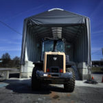 
              A tractor sits in front of a pile of salt used to create a brine that will help clear road of ice and snow ahead of a winter storm at the GDOT's Maintenance Activities Unit location on Friday, Jan. 14, 2022, in Forest Park, Ga. A winter storm is headed south that could effect much of Georgia through Sunday. (AP Photo/Brynn Anderson)
            