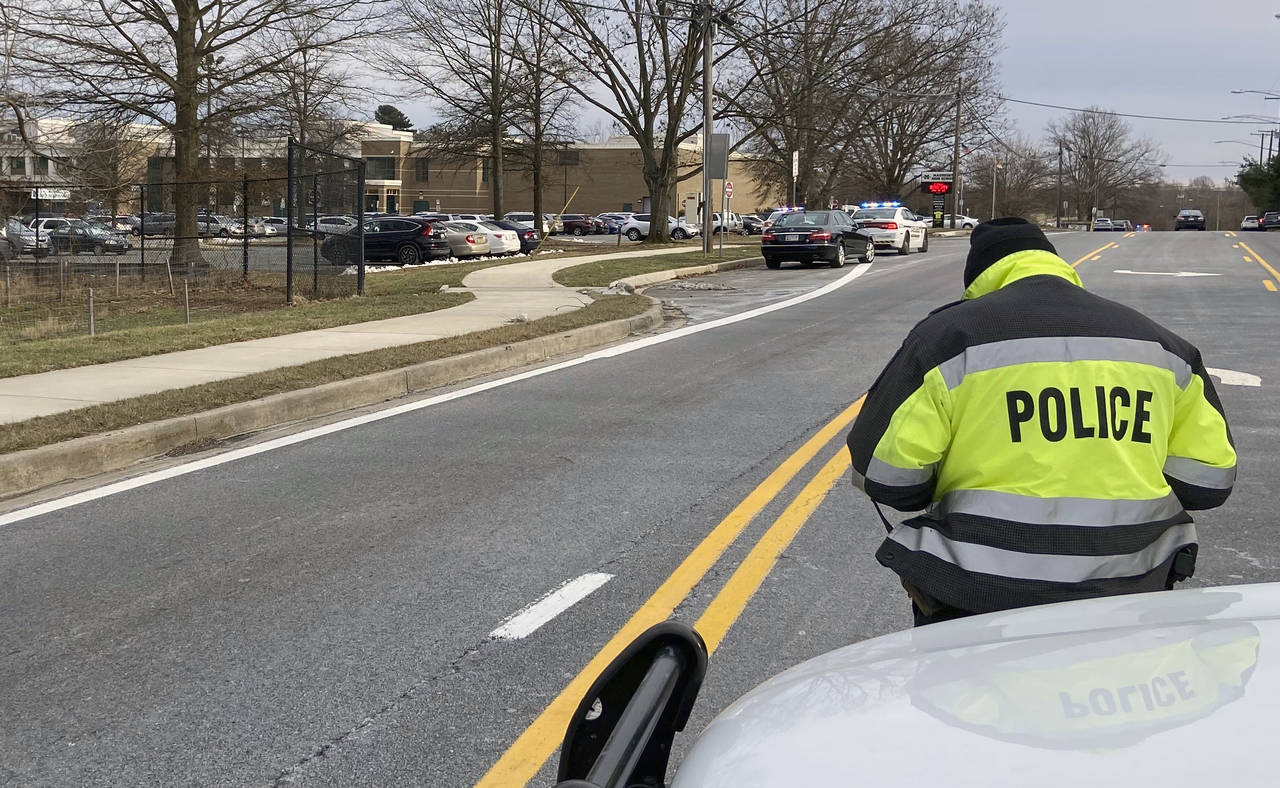 A policeman stands near the scene at Col. Zadok Magruder High School where authorities say a studen...