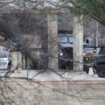 
              CORRECTS BYLINE TO ELIAS VALVERDE INSTEAD OF LYNDA M. GONZALEZ OR SMILEY N. POOL - Law enforcement teams stage near Congregation Beth Israel while conducting SWAT operations in Colleyville, Texas on Saturday afternoon, Jan. 15, 2022. Authorities said a man took hostages Saturday during services at the synagogue where the suspect could be heard ranting in a livestream and demanding the release of a Pakistani neuroscientist who was convicted of trying to kill U.S. Army officers in Afghanistan. (Elias Valverde/The Dallas Morning News via AP)
            
