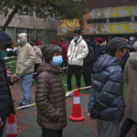 
              Residents wearing face masks to protect from the coronavirus line up for the coronavirus testing at a school in Fengtai District in Beijing, Monday, Jan. 24, 2022. Chinese authorities have lifted a monthlong lockdown of Xi'an and its 13 million residents as infections subside ahead of the Winter Olympics. Meanwhile, the 2 million residents of one Beijing district are being tested following a series of cases in the capital. (AP Photo/Andy Wong)
            