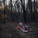 
              FILE - Flowers adorn Anton Black's gravesite in the corner of a cemetery, Jan. 28, 2019, in Kent County, Md.  A federal judge on Tuesday, Jan. 19, 2022, has refused to throw out a lawsuit’s claims that police on Maryland’s Eastern Shore used excessive force on Anton Black, a 19-year-old Black man who died in 2018 during a struggle with officers who handcuffed him and shackled his legs.  (AP Photo/Patrick Semansky, File)
            