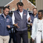 
              FILE-Virginia Gov.-elect, Glenn Youngkin, center, speaks with, Attorney General-elect, Jason Miyares, left, and Lt. Gov.elect, Winsome Sears, right, as they walk from a rally in Fredericksburg, Va., Saturday, Oct. 30, 2021. Virginia will join other Republican-led states and business groups in challenging Biden administration mandates intended to increase the nation's COVID-19 vaccination rate once GOP Gov.-elect Glenn Youngkin and Attorney General-elect Jason Miyares take office. (AP Photo/Steve Helber/FILE)
            