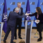 
              NATO Secretary General Jens Stoltenberg, center, looks on as Finland's Foreign Minister Pekka Haavisto, left, greets Sweden's Foreign Minister Ann Linde, right, at the end of a media conference at NATO headquarters in Brussels, Monday, Jan. 24, 2022. (AP Photo/Olivier Matthys)
            