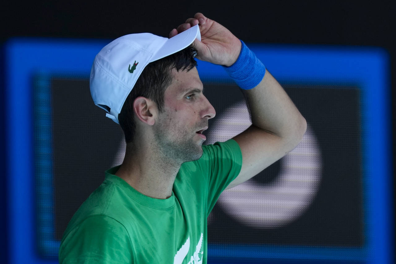 FILE - Defending men's champion Serbia's Novak Djokovic practices on Margaret Court Arena ahead of ...