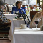 
              FILE - Residents dine together, but socially distant, in the dining hall at RiverWalk, an independent senior housing facility, in New York, April 1, 2021. COVID-19 infections are soaring again at U.S. nursing homes because of the omicron wave, and deaths are climbing too. That's leading to new restrictions on family visits and a renewed push to get more residents and staff members vaccinated and boosted. (AP Photo/Seth Wenig, File)
            