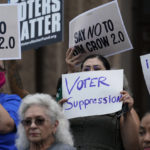 
              FILE - Demonstrators join a rally to protest proposed voting bills on the steps of the Texas Capitol on July 13, 2021, in Austin, Texas. A sweeping new Texas voting law that Republicans muscled through the Legislature last year over dramatic protests is drawing fire again, even before some of the most contentious restrictions and changes kick in ahead of the state's first-in-the nation primary. (AP Photo/Eric Gay, File)
            