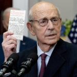 
              Supreme Court Associate Justice Stephen Breyer holds up a copy of the United States Constitution as he announces his retirement in the Roosevelt Room of the White House in Washington, Thursday, Jan. 27, 2022. (AP Photo/Andrew Harnik)
            