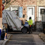 
              A municipal sanitation worker collects trash in Philadelphia, Thursday, Jan. 13, 2022. The omicron variant is sickening so many sanitation workers around the U.S. that waste collection in Philadelphia and other cities has been delayed or suspended. (AP Photo/Matt Rourke)
            