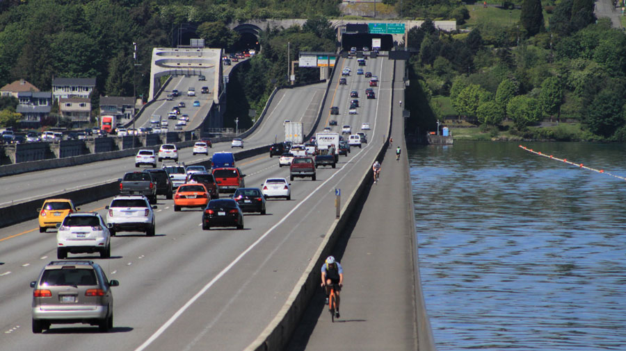 Cars drive across the I-90 floating bridge....