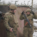 
              A female Ukrainian soldier adjusts her helmet at a frontline position in the Luhansk region, eastern Ukraine, Tuesday, Feb. 1, 2022. Russia accused the West of "whipping up tensions" over Ukraine and said the U.S. had brought "pure Nazis" to power in Kyiv as the U.N. Security Council held a stormy and bellicose debate on Moscow's troop buildup near its southern neighbor. (AP Photo/Vadim Ghirda)
            