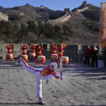 
              Wu Jingyu, China's Taekwondo Olympic Champion, poses with a kick before taking part in the torch relay for the 2022 Winter Olympics at the Badaling Great Wall on the outskirts of Beijing, China, Thursday, Feb. 3, 2022. (AP Photo/Ng Han Guan)
            