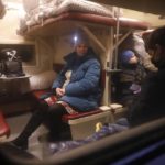 
              People from Donetsk and Luhansk regions, the territory controlled by a pro-Russia separatist governments in eastern Ukraine, sit a train carriage waiting to be taken to temporary residences in the Volgograd region, at the railway station in Volzhsky, Volgograd region, Russia, on Sunday, Feb. 20, 2022. Ukrainian President Volodymyr Zelenskyy, facing a sharp spike in violence in and around territory held by Russia-backed rebels and increasingly dire warnings that Russia plans to invade, has called for Russian President Vladimir Putin to meet him and seek a resolution to the crisis. (AP Photo/Alexandr Kulikov)
            