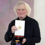 
              Conductor Simon Rattle holds the 'The Order of Merit of the Federal Republic of Germany' after he received it by German President Frank-Walter Steinmeier during a reception at Bellevue palace in Berlin, Germany, Tuesday, Feb. 8, 2022. (AP Photo/Michael Sohn)
            