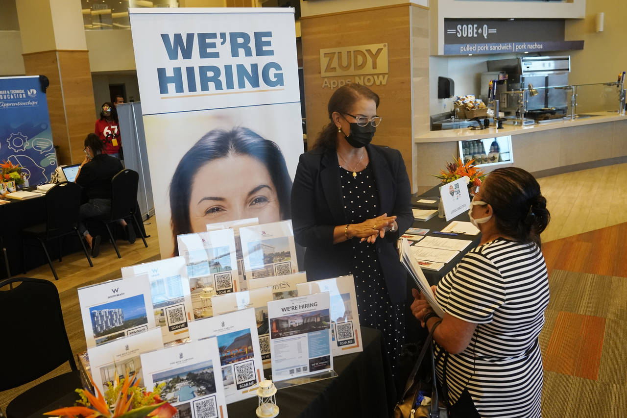 FILE - Marriott human resources recruiter Mariela Cuevas, left, talks to Lisbet Oliveros, during a ...