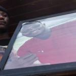 
              A relative holds a framed image of 24 year-old Congolese immigrant Moïse Mugenyi Kabagambe, during a protest to demand justice for his violent death, at Barra da Tijuca beach, in Rio de Janeiro, Brazil, Saturday, Feb. 5, 2022. The assailants were caught on security camera footage attacking the young man on Jan. 24, holding him down and beating him with a rod. (AP Photo/Bruna Prado)
            