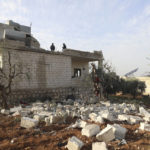 
              People check a destroyed house after an operation by the U.S. military in the Syrian village of Atmeh, in Idlib province, Syria, Thursday, Feb. 3, 2022. U.S. special forces carried out what the Pentagon said was a successful, large-scale counterterrorism raid in northwestern Syria early Thursday. Local residents and activists said civilians were also among the dead. (AP Photo/Ghaith Alsayed)
            