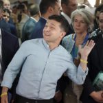
              FILE Ukrainian President Volodymyr Zelenskyy, center, gestures as he arrives at a polling station during a parliamentary election in Kiev, Ukraine, Sunday, July 21, 2019. As a political novice making an unlikely run to be Ukraine's president, Volodymyr Zelenskyy vowed to reach out to Russia-backed rebels in the east who were fighting Ukrainian forces and make strides toward resolving the conflict. (AP Photo/Evgeniy Maloletka, File)
            