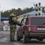 
              A Ukrainian border guard officer checks a car at the Ukrainian Belarusian state border checkpoint Novi Yarylovychi, Ukraine, Monday, Feb.21, 2022. (AP Photo/Oleksandr Ratushniak)
            