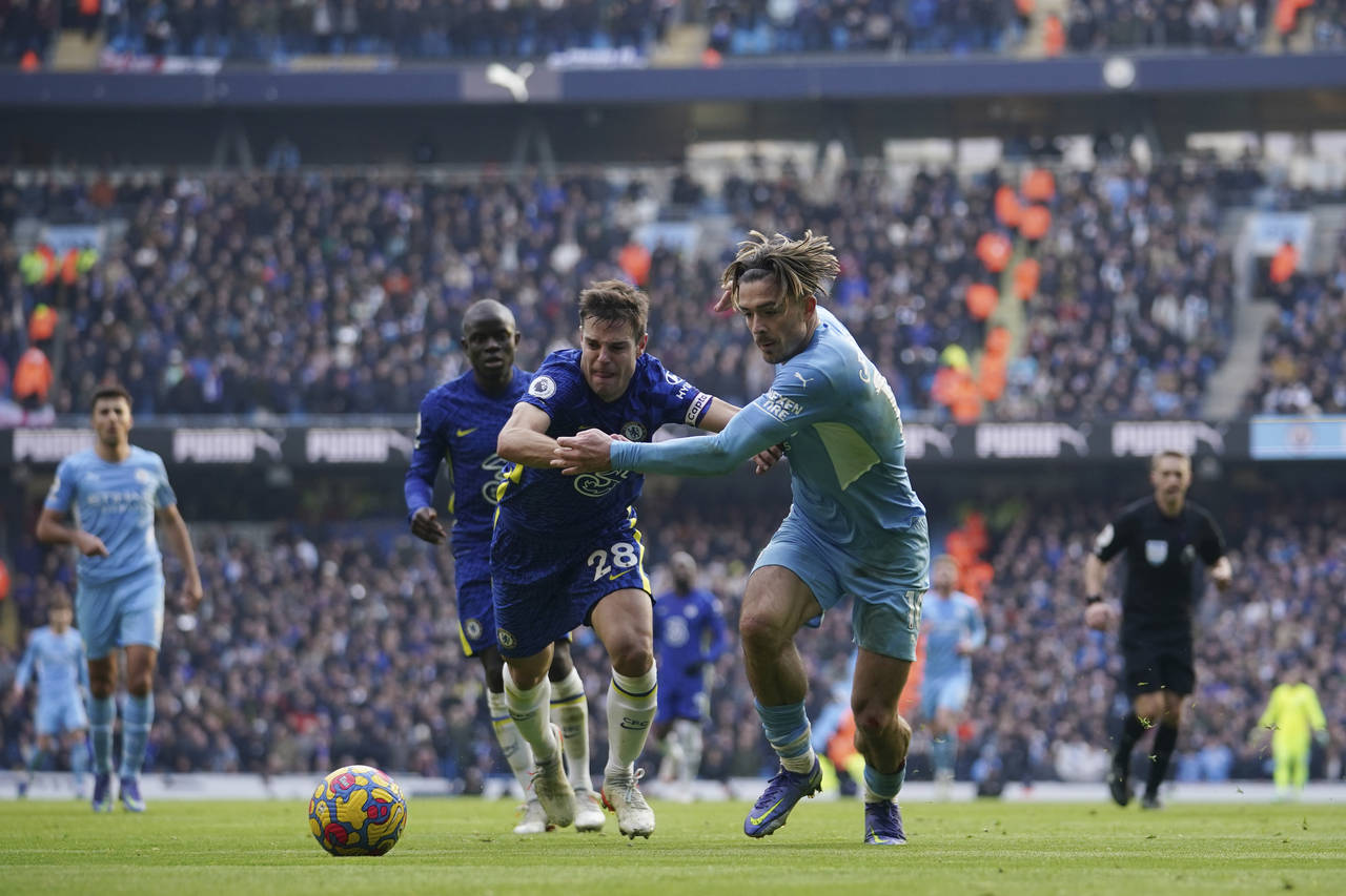 Manchester City's Jack Grealish, centre right, challenges for the ball with Chelsea's Cesar Azpilic...