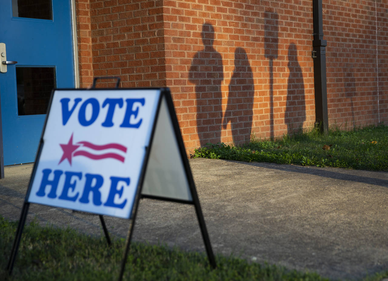 FILE - Voters wait outside the Lee Hill polling location on Election Day in Spotsylvania, Va., Nov....