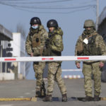 
              Ukrainian border guards stand at a checkpoint from territory controlled by Russia-backed separatists to the territory controlled by Ukrainian forces in Novotroitske, eastern Ukraine, Monday, Feb. 21, 2022. World leaders are making another diplomatic push in hopes of preventing a Russian invasion of Ukraine, even as heavy shelling continues in Ukraine's east. (AP Photo/Evgeniy Maloletka)
            